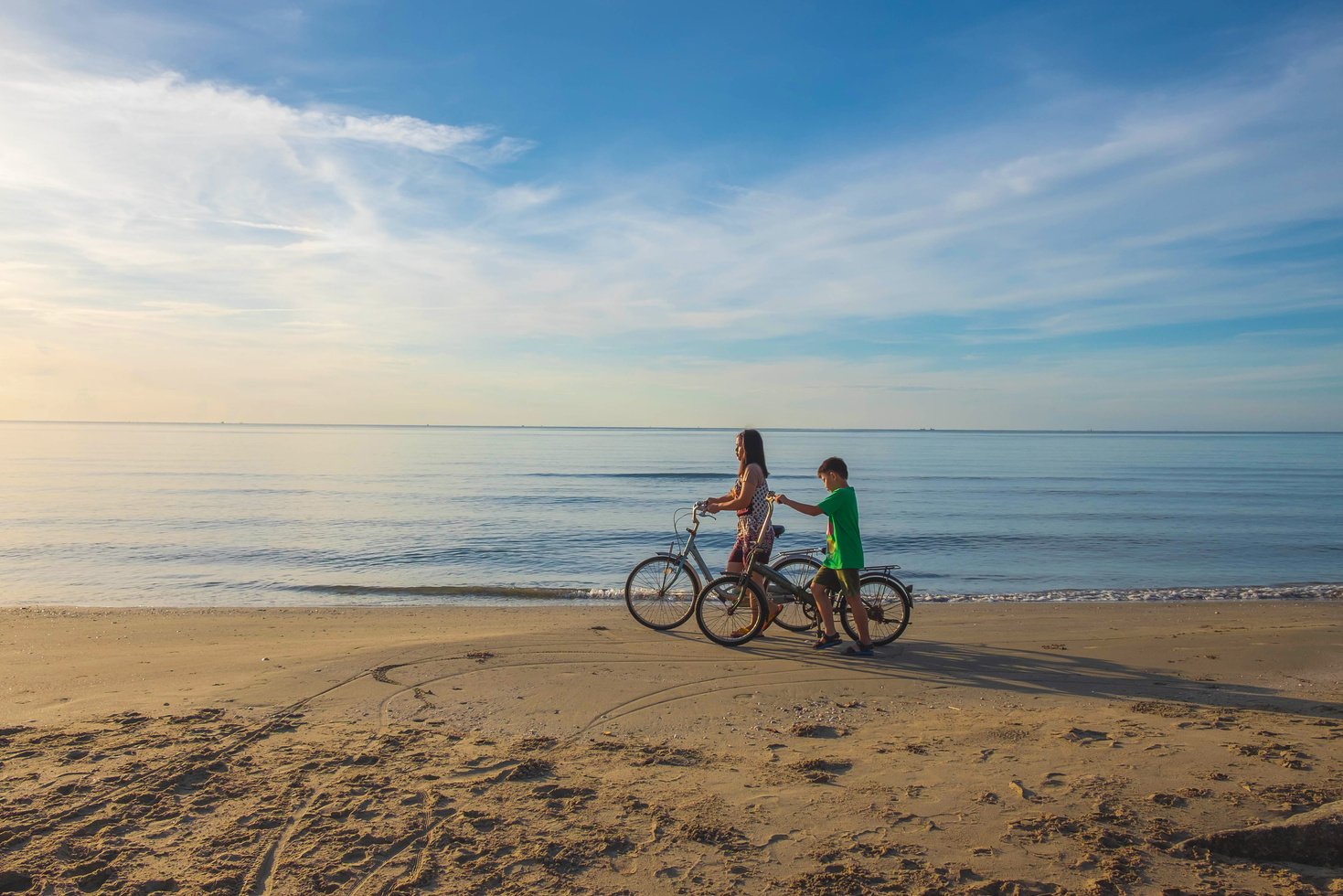 Mother and Son Riding Bicycles at the Beach